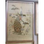 An eastern silk emboidered picture, peacock and foliage, 97cm x 66cm, framed and glazed. Live