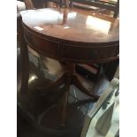 A reproduction mahogany drum table Live bidding available via our website, if you require P&P please