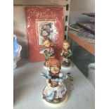 Three large Hummel figures with Hummel book Live bidding available via our website, if you require