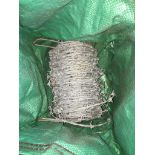 A bag containing a roll of barbed wire Live bidding available via our website, if you require P&P