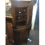 An oak corner cabinet Live bidding available via our website, if you require P&P please read