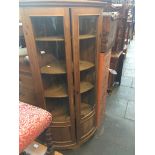 A pine bow front glazed corner cabinet, h186cm, w87cm, d60cm. Live bidding available via our