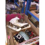 A pair of vintage ice skates, a box with small items inc camera, wine stopper, and a plated