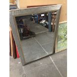 A large bevelled mirror 105 x 75 cm Live bidding available via our website, if you require P&P