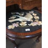 A mahogany cabriole leg round coffee table with woven picture under glass top. Live bidding