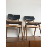 A pair of mid 20th century chairs with black rexene upholstery. Live bidding available via our