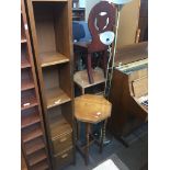 A pine narrow tall bookcase/cd case and an oak octagonal occasional table Live bidding available via
