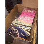 A box with cigarette card collection and two boxed singing Coke cans Live bidding available via