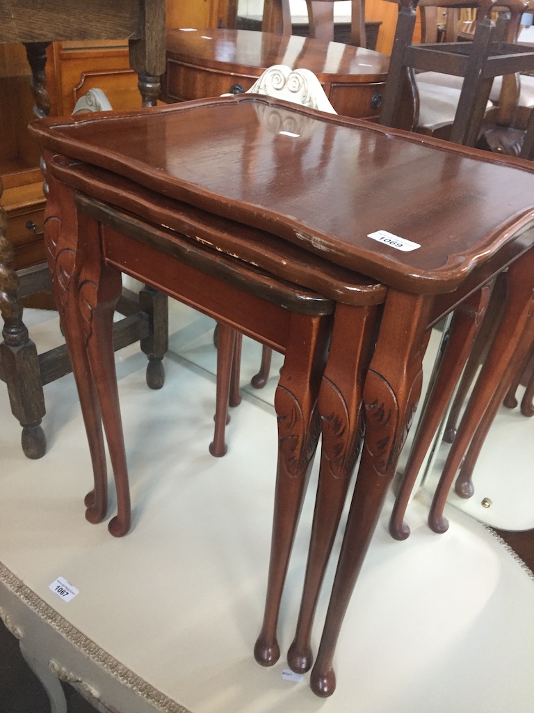 A mahogany nest of tables on cabriole legs Live bidding available via our website, if you require