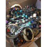 A box of costume jewellery Live bidding available via our website, if you require P&P please read