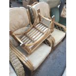A pair of cane conservatory armchairs and foot stool Live bidding available via our website, if