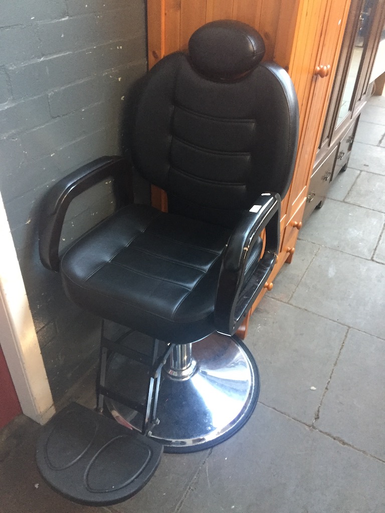 An adjustable barbers chair - left arm damaged. Live bidding available via our website, if you