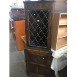 An oak and leaded glass corner cabinet Live bidding available via our website, if you require P&P