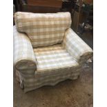 A chequered patterned armchair Live bidding available via our website, if you require P&P please