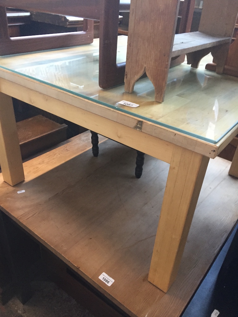 A light wood square coffee table Live bidding available via our website, if you require P&P please