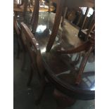 A walnut dining table on cabriole legs together with 6 splat back chairs, table h75cm, L168cm,