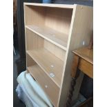 A light wood effect bookcase Live bidding available via our website, if you require P&P please