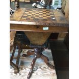 A 19th century walnut pedestal sewing table with chess top.