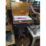 A Victorian walnut pedestal sewing table