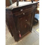 A Georgian inlaid oak corner cupboard