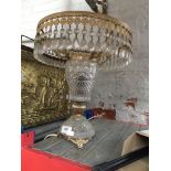 A brass and glass table lamp with glass droplets.