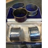 A pair of cased hallmarked silver serviette rings, another hallmarked silver serviette ring, one