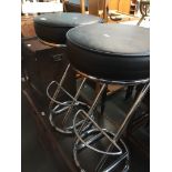 A pair of chrome based kitchen bar stools