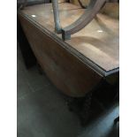 An oak gate leg table with barley twist legs