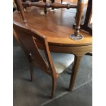 A Nathan furniture teak round extending dining table with four G-Plan chairs