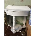 A white painted demi lune hall table