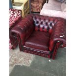An oxblood leather Chesterfield armchair