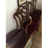 A set of 4 victorian carved dining chairs with red upholstery