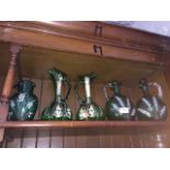 Victorian green and gilt glass inc. a pair of decanters, two claret jugs and another jug