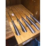 A wooden block set of 5 kitchen knives