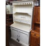 A large cream painted dresser