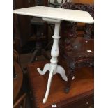 A white painted tripod table