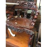 A reproduction carved Eastern armchair