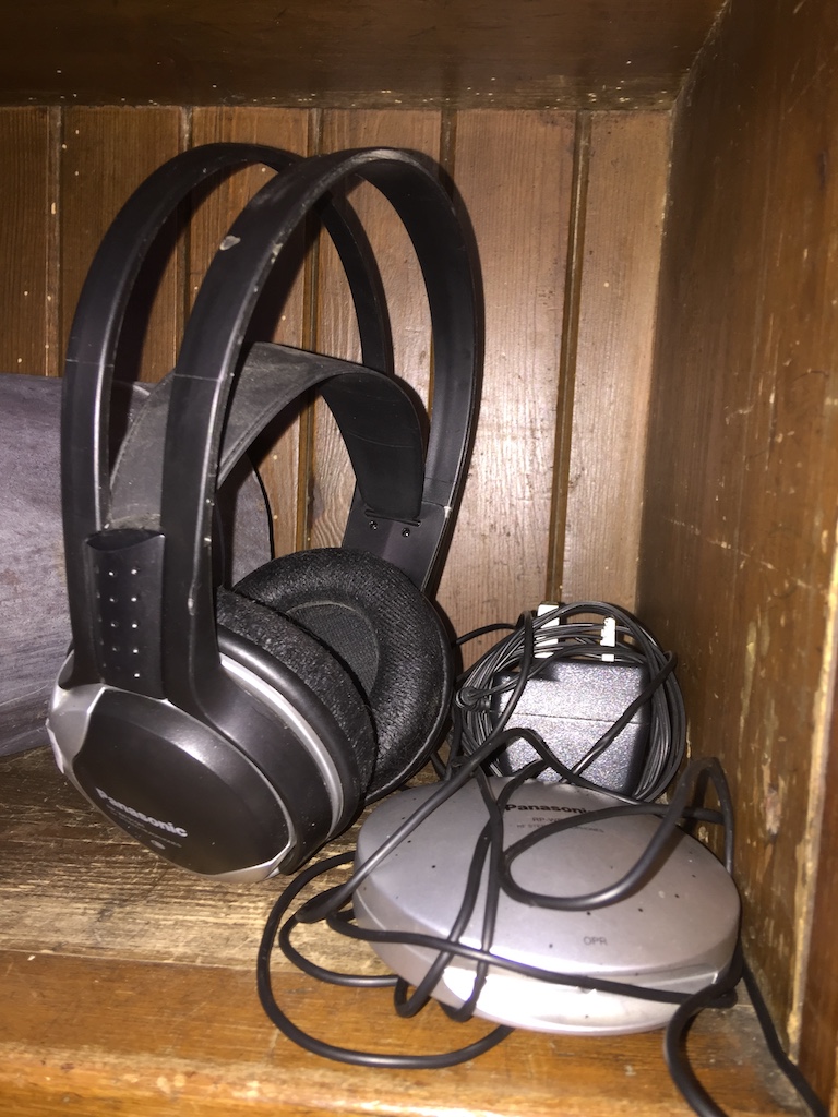 A set of Panasonic cordless headphones RP WF910H with docking station and charging cable