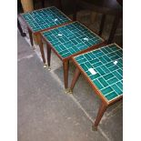 A set of three retro tile top small tables on tapered legs