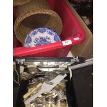 Red crate with boxed cutlery, basket and plates