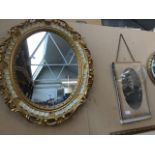 Ornate oval mirror and an Edwardian photograph