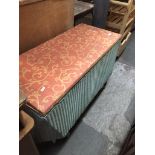 A Lloyd Loom bedding box on castors