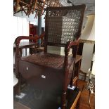 A bergere back commode chair