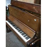 A 1936 Carl Bechstein upright piano in walnut, serial no. 141016.