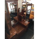 An Edwardian mahogany dressing table chest with large central swing mirror flanked by small mirrored