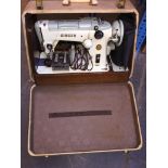 An electric Singer sewing machine with accessories, lead and foot pedal in case