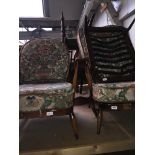 A pair of Ercol low armchairs with fleur de lys backs and an Ercol foot stool