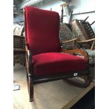 A 19th century mahogany rocker with red velour upholstery.