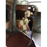 A brass framed picture/mirror fire screen