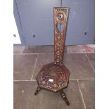 An oak spinner's chair with Celtic style carved back, height 87cm.